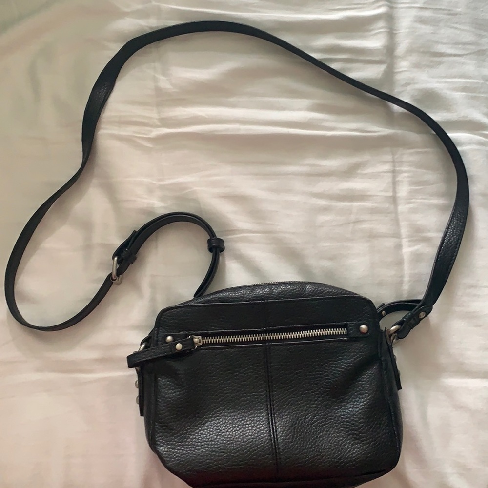 Black Target brand cross-body bag with zipper opening and multiple pockets